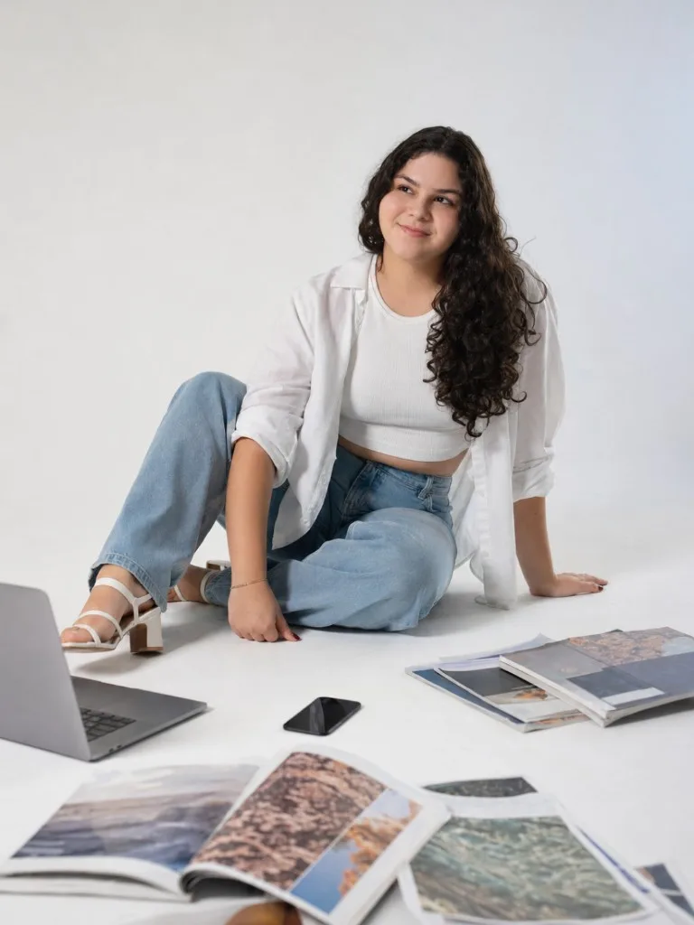 Ensaio gerado com IA: fundo branco, laptop e revistas no chão.